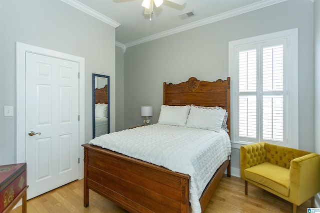 4650 Nicholas Dr, Bessemer, AL 35022 - bedroom featuring light wood-style floors, crown molding, multiple windows, and a ceiling fan