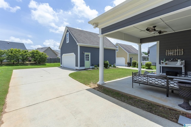 4650 Nicholas Dr, Bessemer, AL 35022 - view of patio with a garage, an outbuilding, a ceiling fan, and concrete driveway