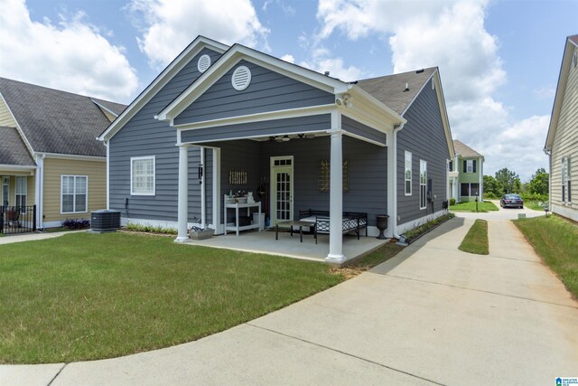 4650 Nicholas Dr, Bessemer, AL 35022 - rear view of house featuring a yard, driveway, a patio, a shingled roof, and outdoor lounge area