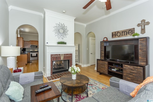 4650 Nicholas Dr, Bessemer, AL 35022 - living area featuring ornamental molding, ceiling fan, light wood-type flooring, arched walkways, and a fireplace