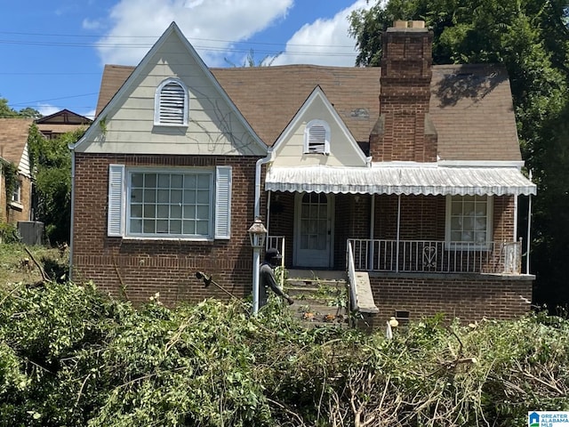 1420 47th St, Birmingham, AL 35208 - view of front facade featuring brick siding, a chimney, and covered porch