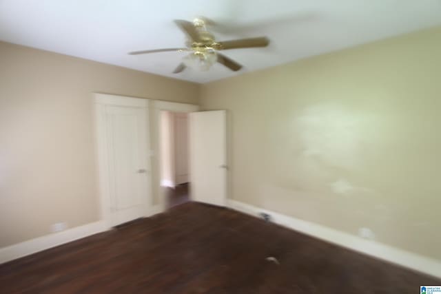 1420 47th St, Birmingham, AL 35208 - unfurnished bedroom with dark wood-type flooring, a closet, and ceiling fan