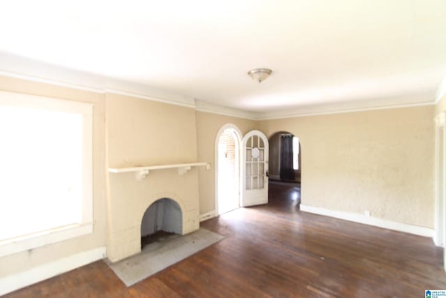 1420 47th St, Birmingham, AL 35208 - unfurnished living room with arched walkways, ornamental molding, plenty of natural light, and wood finished floors
