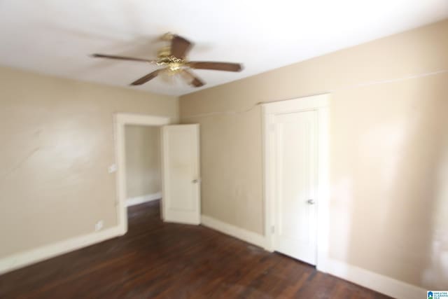 1420 47th St, Birmingham, AL 35208 - unfurnished bedroom featuring dark wood-style floors, ceiling fan, and a closet