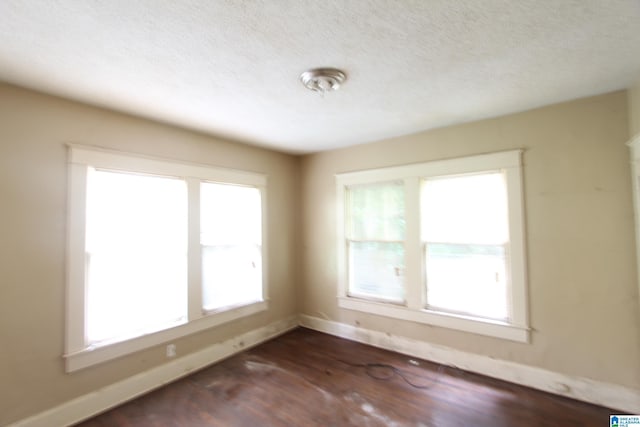1420 47th St, Birmingham, AL 35208 - empty room with plenty of natural light, dark wood-type flooring, and a textured ceiling