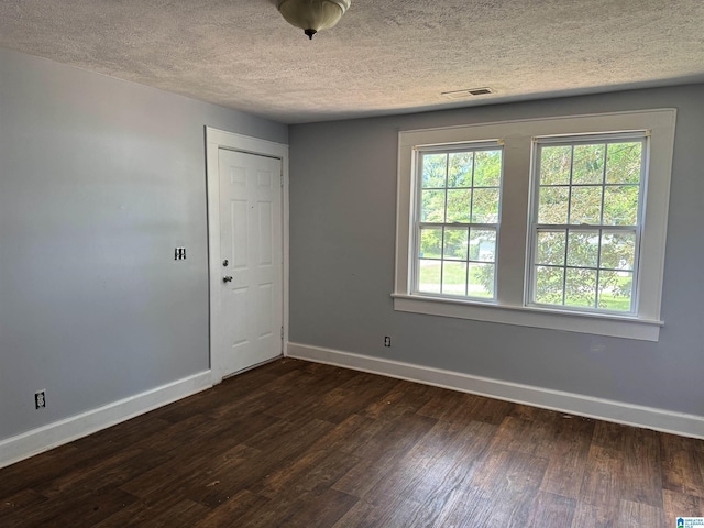 319 Lapsley Ave, Anniston, AL 36207 - spare room with dark wood-type flooring and a textured ceiling