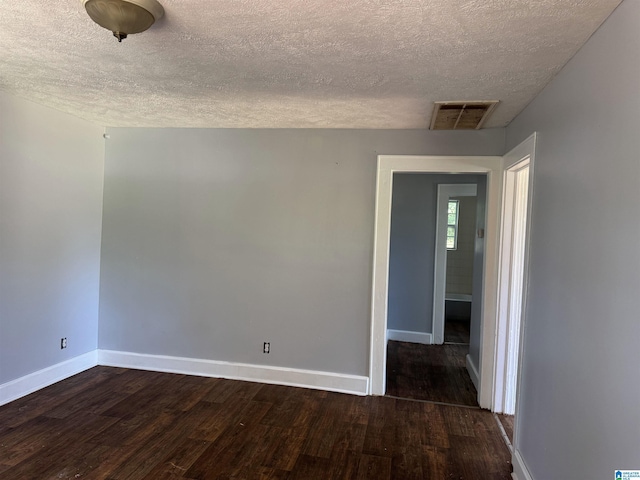 319 Lapsley Ave, Anniston, AL 36207 - empty room featuring a textured ceiling and dark wood-type flooring
