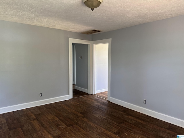 319 Lapsley Ave, Anniston, AL 36207 - spare room with a textured ceiling and dark wood-style floors