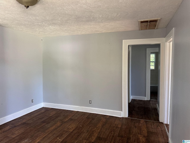 319 Lapsley Ave, Anniston, AL 36207 - unfurnished room with a textured ceiling and dark wood finished floors