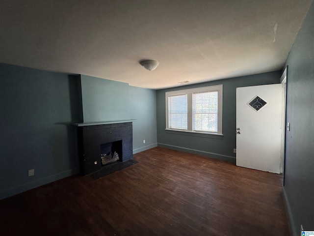 319 Lapsley Ave, Anniston, AL 36207 - unfurnished living room with wood finished floors and a fireplace