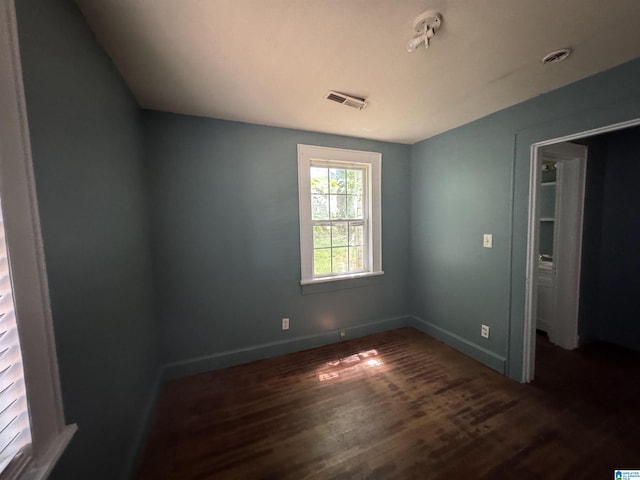 319 Lapsley Ave, Anniston, AL 36207 - unfurnished bedroom featuring dark wood-type flooring and baseboards