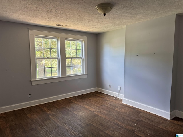 319 Lapsley Ave, Anniston, AL 36207 - unfurnished room with a textured ceiling and dark wood-type flooring