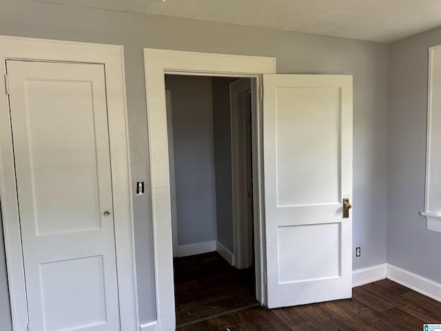 319 Lapsley Ave, Anniston, AL 36207 - unfurnished bedroom featuring dark wood-type flooring and baseboards