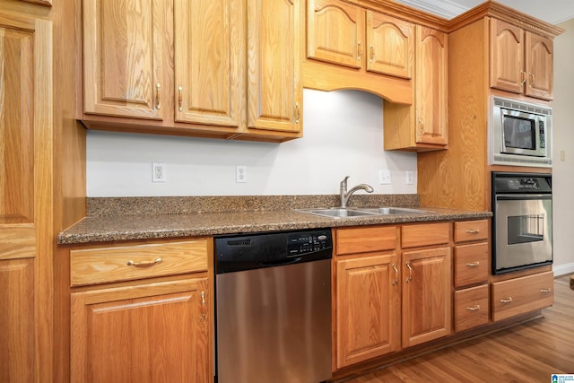 1819 Calgary Dr, Birmingham, AL 35022 - kitchen featuring appliances with stainless steel finishes, dark countertops, and wood finished floors
