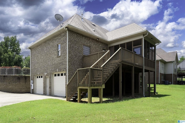 1819 Calgary Dr, Birmingham, AL 35022 - back of property featuring stairway, an attached garage, a lawn, and roof with shingles