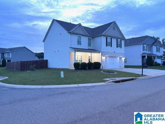 6497 Newbridge Dr, Bessemer, AL 35022 - view of front of home featuring driveway, an attached garage, and board and batten siding