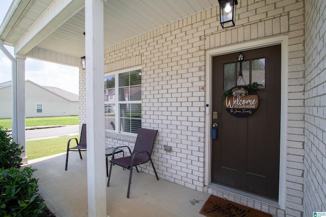 6497 Newbridge Dr, Bessemer, AL 35022 - doorway to property with covered porch and brick siding