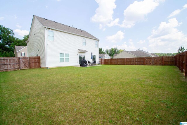 6497 Newbridge Dr, Bessemer, AL 35022 - back of house featuring a fenced backyard, a gate, and a patio area