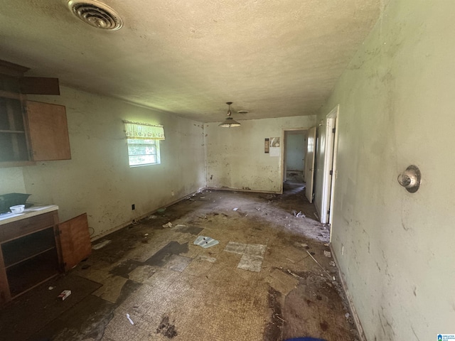 1412 S 7th St, Lanett, AL 36863 - unfurnished dining area with a textured ceiling
