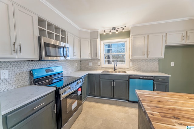 1025 Old Mill Rd, Anniston, AL 36207 - kitchen with appliances with stainless steel finishes, wood counters, white cabinetry, open shelves, and ornamental molding