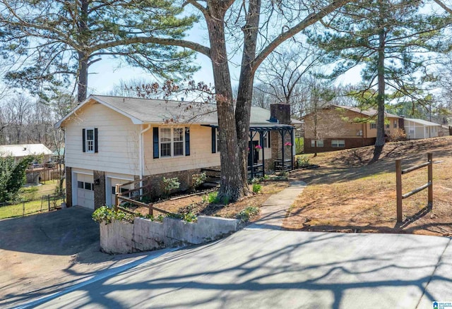 1025 Old Mill Rd, Anniston, AL 36207 - ranch-style house featuring driveway, an attached garage, a chimney, and covered porch