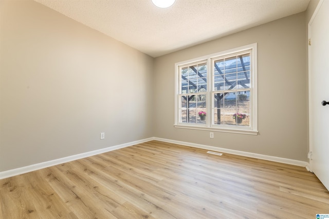 1025 Old Mill Rd, Anniston, AL 36207 - empty room featuring light wood-style floors and a textured ceiling