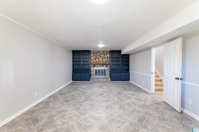 1025 Old Mill Rd, Anniston, AL 36207 - unfurnished living room featuring a stone fireplace, built in shelves, and ornamental molding