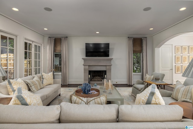 3600 Park Ln S, Mountain Brook, AL 35213 - living area with arched walkways, recessed lighting, wood finished floors, a fireplace, and ornamental molding