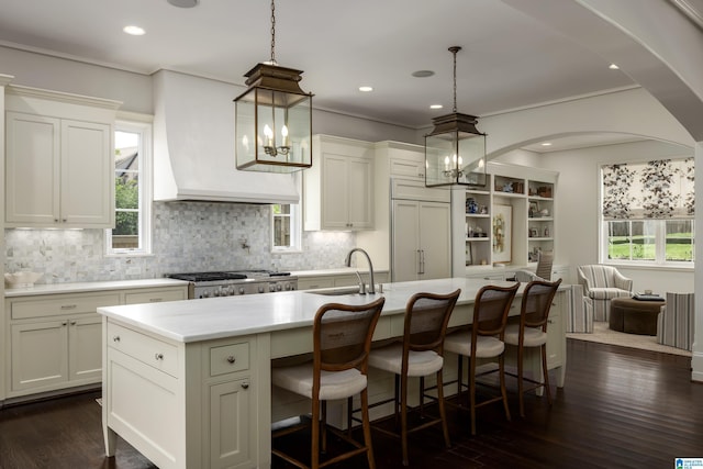 3600 Park Ln S, Mountain Brook, AL 35213 - kitchen with light countertops, decorative backsplash, dark wood-type flooring, a center island with sink, and recessed lighting