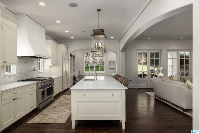 3600 Park Ln S, Mountain Brook, AL 35213 - kitchen featuring high end appliances, arched walkways, open floor plan, premium range hood, and recessed lighting