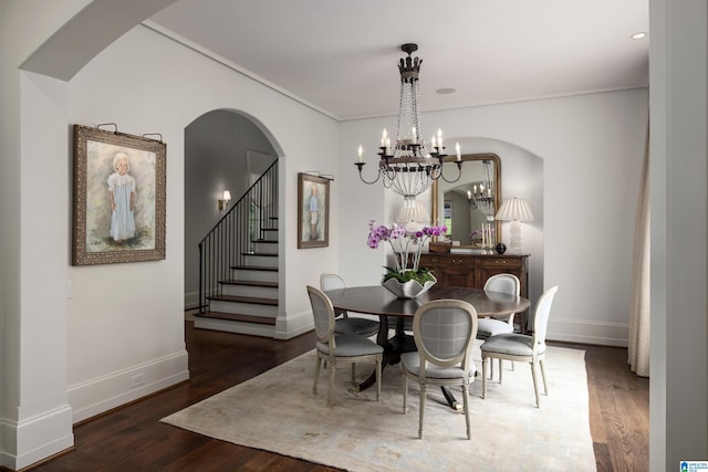 3600 Park Ln S, Mountain Brook, AL 35213 - dining space featuring wood finished floors, arched walkways, a chandelier, stairway, and ornamental molding