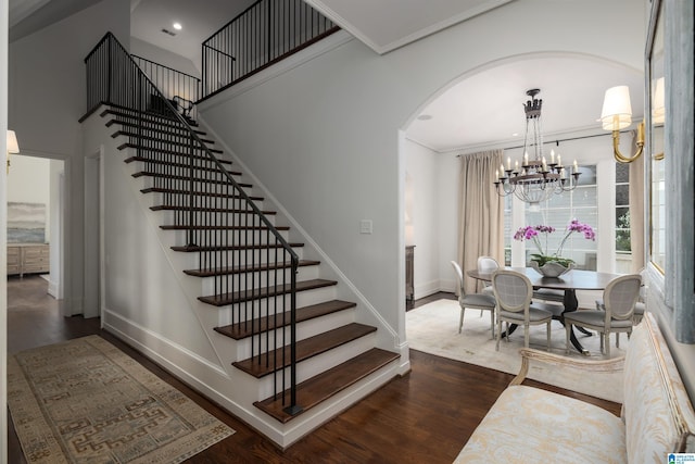 3600 Park Ln S, Mountain Brook, AL 35213 - staircase featuring wood finished floors, arched walkways, a chandelier, crown molding, and recessed lighting