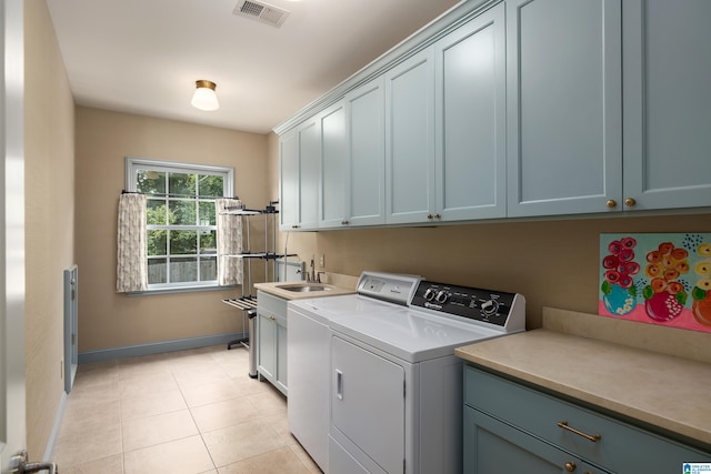 3600 Park Ln S, Mountain Brook, AL 35213 - laundry area with cabinet space, washer and dryer, and light tile patterned flooring