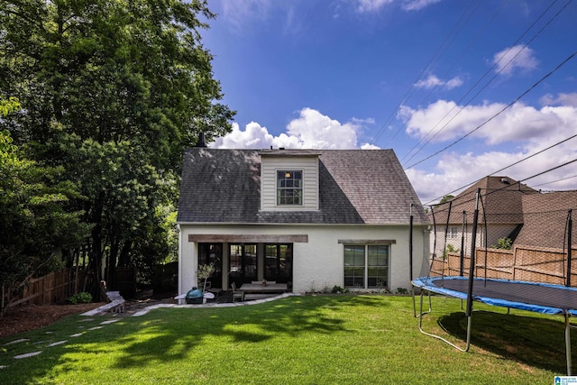 3600 Park Ln S, Mountain Brook, AL 35213 - back of property with a trampoline, brick siding, a shingled roof, and a patio