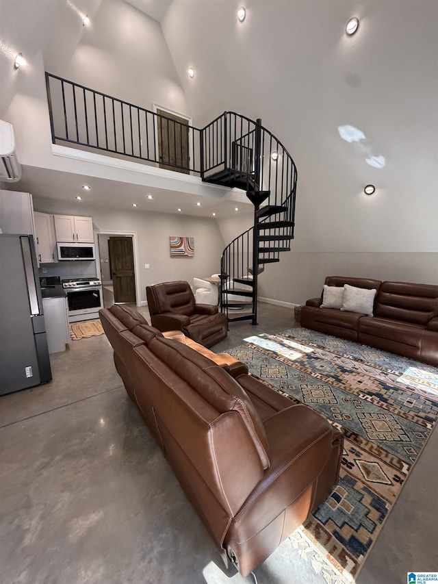 1926 County Road 621 S, Woodland, AL 36280 - living area with high vaulted ceiling, finished concrete flooring, stairs, a wall mounted air conditioner, and recessed lighting