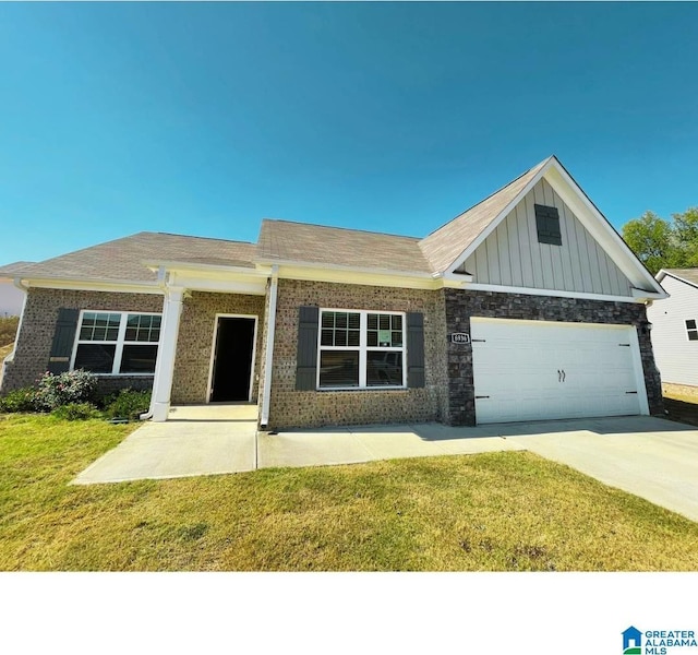 6936 Brandi Cir, Pinson, AL 35126 - view of front facade featuring a front yard, board and batten siding, driveway, an attached garage, and brick siding