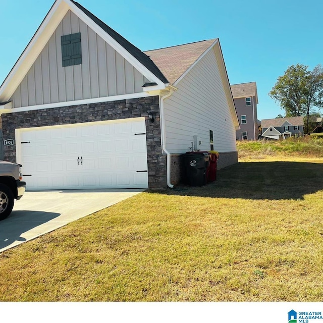 6936 Brandi Cir, Pinson, AL 35126 - view of home's exterior featuring board and batten siding, stone siding, an attached garage, and a yard