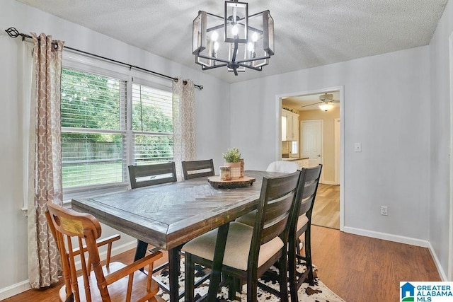 2089 Edenwood Cir, Hueytown, AL 35023 - dining room featuring a chandelier, a textured ceiling, and light wood-style flooring