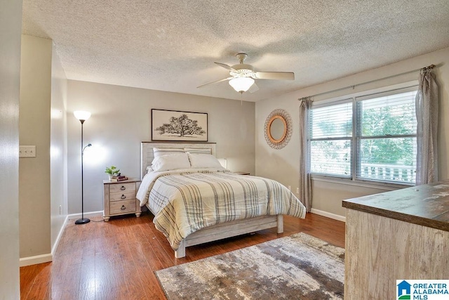 2089 Edenwood Cir, Hueytown, AL 35023 - bedroom with wood finished floors, a textured ceiling, and a ceiling fan