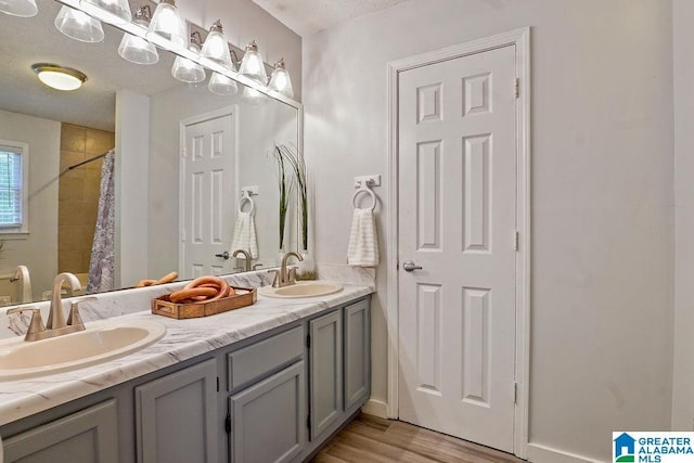 2089 Edenwood Cir, Hueytown, AL 35023 - full bath with double vanity, wood finished floors, and a shower with curtain