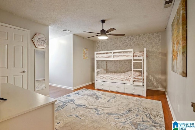 2089 Edenwood Cir, Hueytown, AL 35023 - bedroom featuring wood finished floors, a textured ceiling, and a ceiling fan