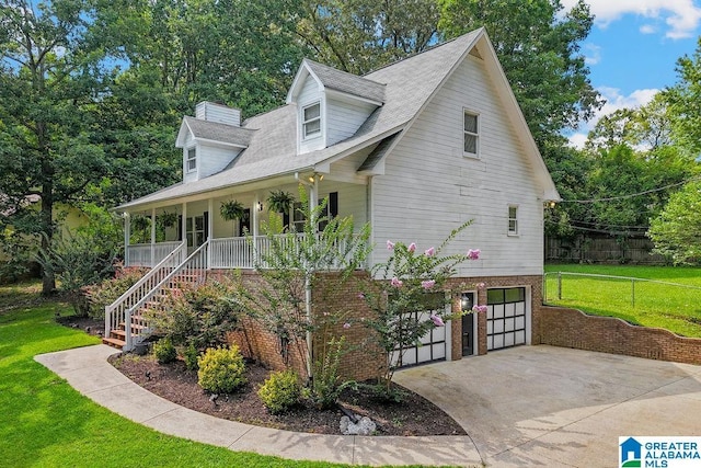 2089 Edenwood Cir, Hueytown, AL 35023 - view of front of home with driveway, covered porch, an attached garage, stairway, and brick siding