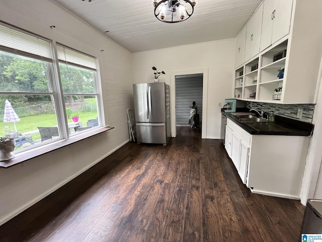 211 3rd St N, Pell City, AL 35125 - kitchen with freestanding refrigerator, dark countertops, open shelves, dark wood-type flooring, and white cabinets