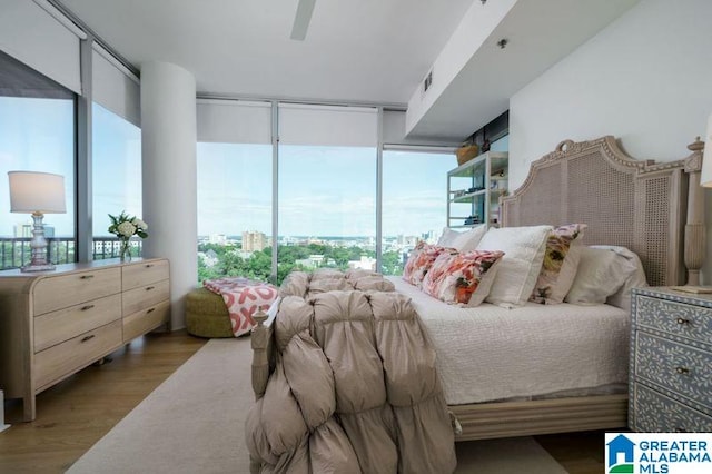 1300 27th Pl Unit 65, Birmingham, AL 35205 - bedroom featuring wood finished floors, expansive windows, and a ceiling fan
