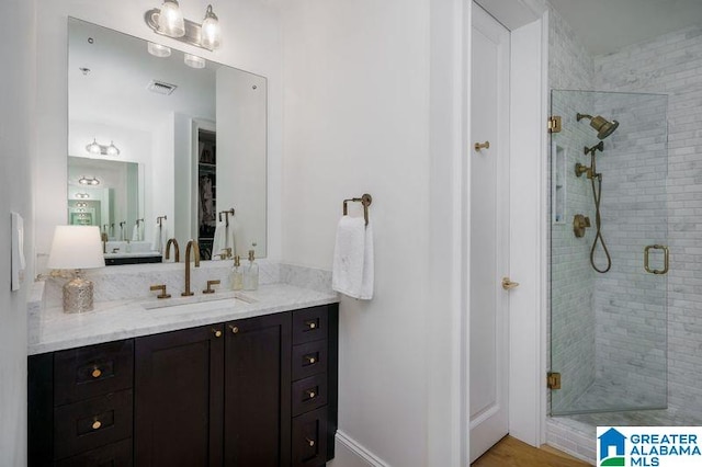 1300 27th Pl Unit 65, Birmingham, AL 35205 - bathroom with vanity, a shower stall, and a closet