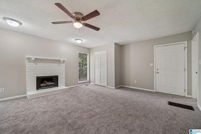 5919 Creekwood Rd, Irondale, AL 35210 - unfurnished living room with a ceiling fan, carpet floors, a textured ceiling, and a fireplace