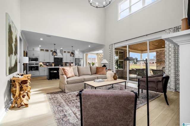 0222 Blackridge Cir, Hoover, AL 35244 - living room featuring a towering ceiling, light wood finished floors, and a chandelier
