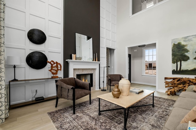 0222 Blackridge Cir, Hoover, AL 35244 - living room featuring a towering ceiling, a lit fireplace, and light wood-type flooring