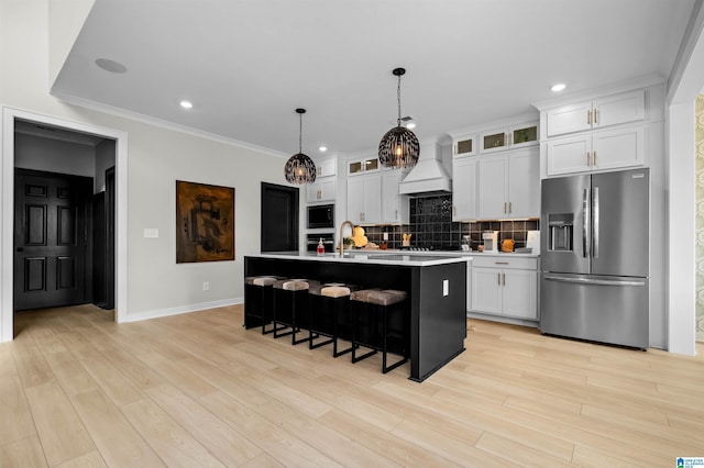0222 Blackridge Cir, Hoover, AL 35244 - kitchen featuring appliances with stainless steel finishes, premium range hood, a kitchen breakfast bar, tasteful backsplash, and white cabinetry