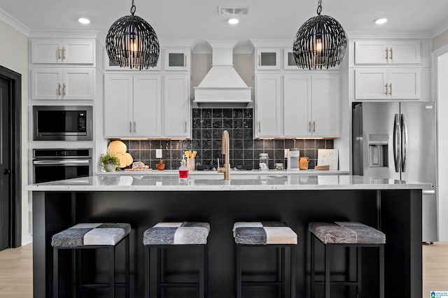 0222 Blackridge Cir, Hoover, AL 35244 - kitchen featuring stainless steel appliances, custom exhaust hood, white cabinetry, and recessed lighting